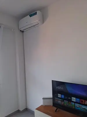 a room with a television and a white wall at Apartamento Estoril in Sal Rei