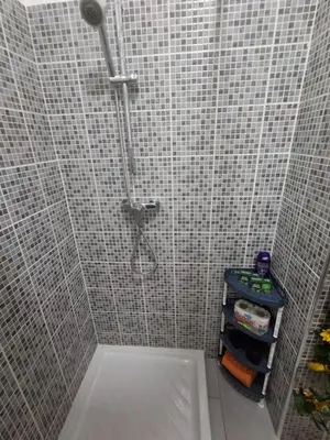 a shower in a bathroom with a tile wall at Apartamento Estoril in Sal Rei