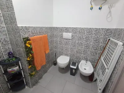 a small bathroom with a toilet and a sink at Apartamento Estoril in Sal Rei