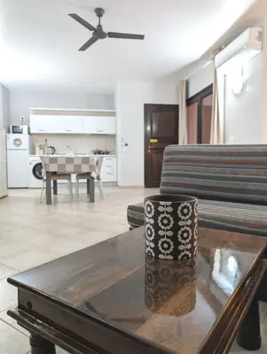 a living room with a couch and a table at SUNSENT GLOW - Tropical Apt N11 - PointingCaboVerde in Santa Maria