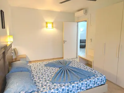 a bedroom with a bed with a blue umbrella on it at SUNSENT GLOW - Tropical Apt N11 - PointingCaboVerde in Santa Maria