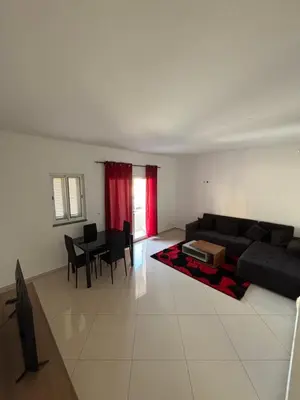 a living room with a couch and a table at La casa de iman in Praia