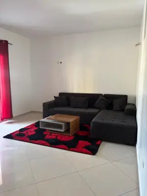 a living room with a black couch and a table at La casa de iman in Praia