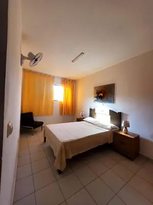 a bedroom with a bed and a chair in it at Comfort T2 in Espargos