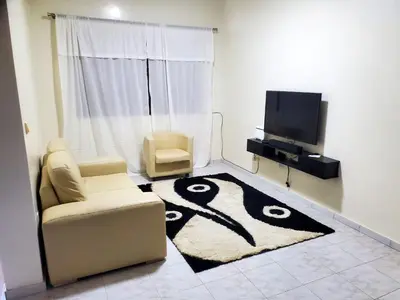 a living room with a couch and a tv at Comfort T2 in Espargos