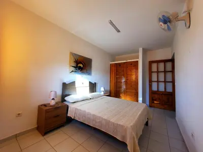 a bedroom with a bed and a dresser and a window at Comfort T2 in Espargos