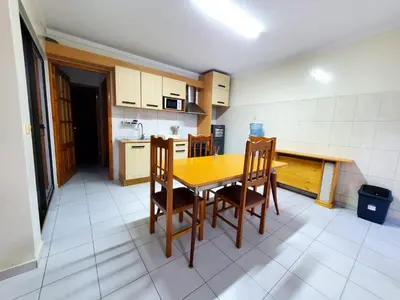 a kitchen with a wooden table and chairs at Comfort T2 in Espargos