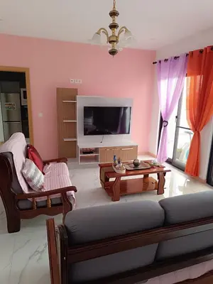 a living room with a couch and a tv at Apartament in Praia in Praia