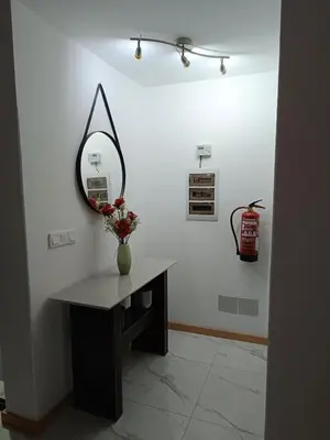 a room with a table and a mirror on a wall at Apartament in Praia in Praia