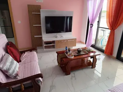 a living room with a tv and a coffee table at Apartament in Praia in Praia