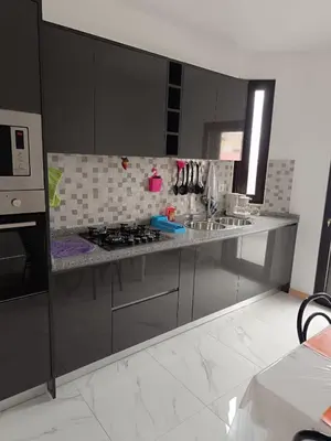 a kitchen with stainless steel cabinets and a stove at Apartament in Praia in Praia