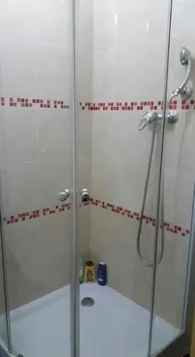 a shower with a glass door in a bathroom at Chez Zuzu in Mindelo