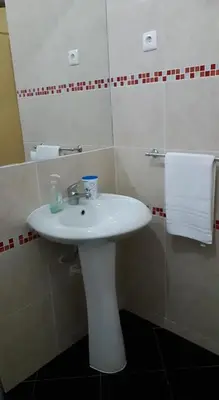 a bathroom with a white sink and a mirror at Chez Zuzu in Mindelo