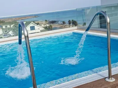 a swimming pool with a water fountain in a building at Luxury Lux Studio with Seaview in Santa Maria