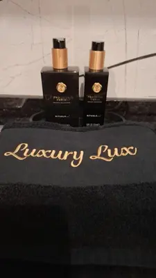 three bottles of luxury fluid sitting on top of a table at Luxury Lux Studio with Seaview in Santa Maria