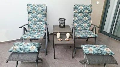 two chairs and a table with a side table at Luxury Lux Studio with Seaview in Santa Maria
