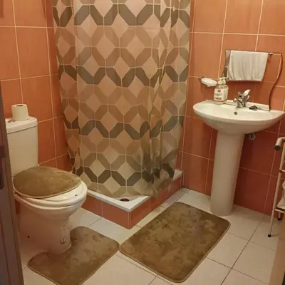 a bathroom with a toilet and a sink and a shower at ManubelaRelax in Praia