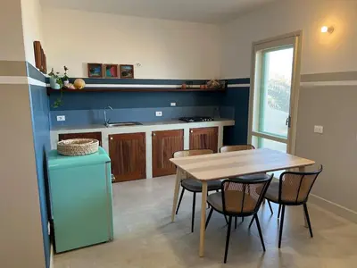 a kitchen with a table and chairs in a room at Extraordinary sea view in Sal Rei