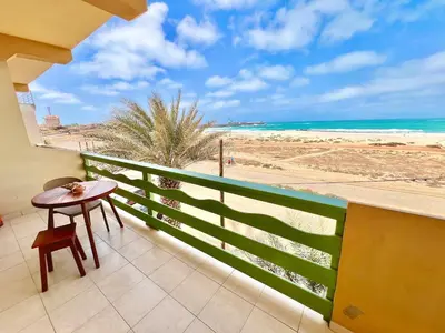 a balcony with a table and a view of the beach at Extraordinary sea view in Sal Rei