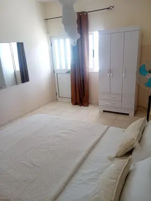 a bedroom with a large white bed in a room at ANGÉLICA RÉSIDENCE Centre-ville 350 m plage in Tarrafal