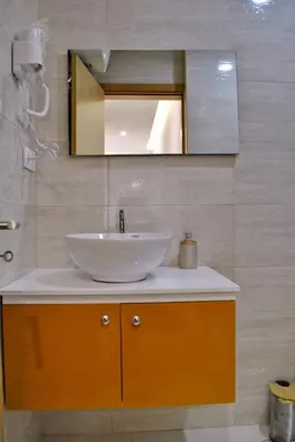 a bathroom with a sink and a mirror at Brisa Suites in Santa Maria