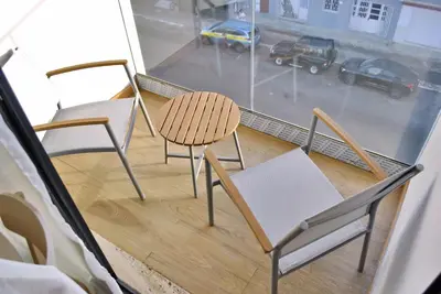 two chairs and a table on a balcony at Brisa Suites in Santa Maria