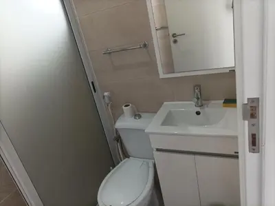a small bathroom with a toilet and a sink at LBranco in Porto Novo