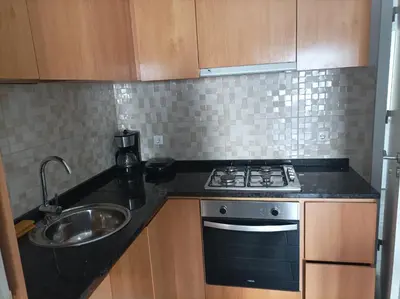 a small kitchen with a stove and a sink at LBranco in Porto Novo