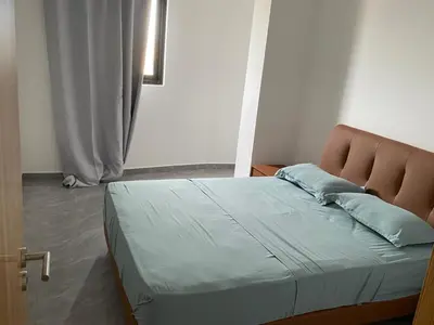 a bedroom with a bed with a brown headboard at Casa grande aluminum Ida in Sal Rei