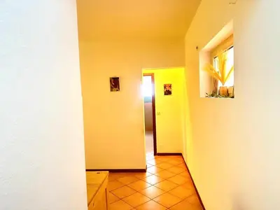 a hallway with yellow walls and a hallway with a door at near the beach On bedroom flat very good in Santa Maria