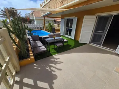 a patio with a table and chairs and a pool at La Vedetta Bella Vista Ocean View II in Santa Maria