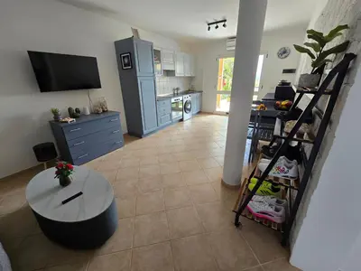 a living room with a table and a kitchen at La Vedetta Bella Vista Ocean View II in Santa Maria