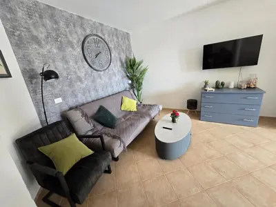 a living room with a couch and a table at La Vedetta Bella Vista Ocean View II in Santa Maria