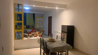 a dining room with a table and a refrigerator at Beach Village Rest in Tarrafal