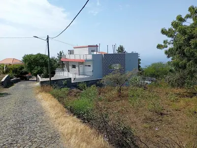 a house sitting on top of a hill next to a road at Ocean view country house in São Filipe