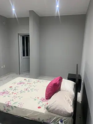 a bed with a pink pillow on it in a room at Ocean view country house in São Filipe