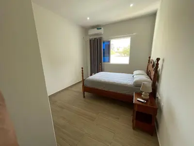 a small bedroom with a bed and a window at Brand New 2-Bedroom Apartment with AC & Fast Wi-Fi in São Filipe