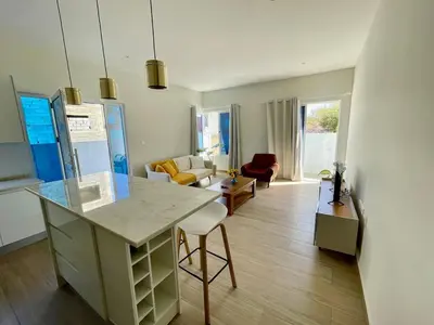 a kitchen and living room with a island in a room at Brand New 2-Bedroom Apartment with AC & Fast Wi-Fi in São Filipe