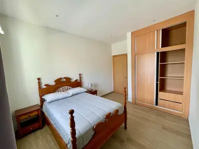 a bedroom with a bed and a large window at Brand New 2-Bedroom Apartment with AC & Fast Wi-Fi in São Filipe