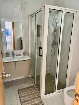 a bathroom with a shower and a sink at Brand New 2-Bedroom Apartment with AC & Fast Wi-Fi in São Filipe