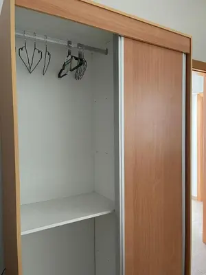 a closet with some glasses hanging on a rack at Brand New 2-Bedroom Apartment with AC & Fast Wi-Fi in São Filipe