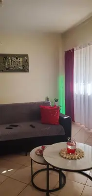 a living room with a couch and a table at Apart savane in São Filipe