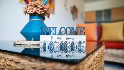 a wicker basket with a welcome sign on a table at Sunny & Cosy Flat in Vila Verde near Bikini Beach! in Prainha