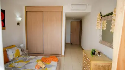 a small bedroom with a bed and a door at Sunny & Cosy Flat in Vila Verde near Bikini Beach! in Prainha