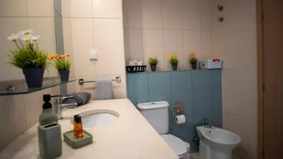 a bathroom with a sink and a toilet at Sunny & Cosy Flat in Vila Verde near Bikini Beach! in Prainha