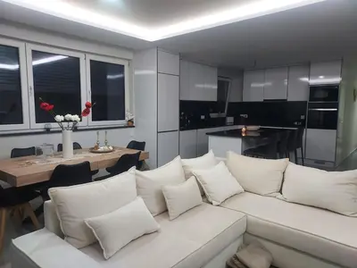 a living room with a white couch and a table at Appartement Vue Mer in Mindelo