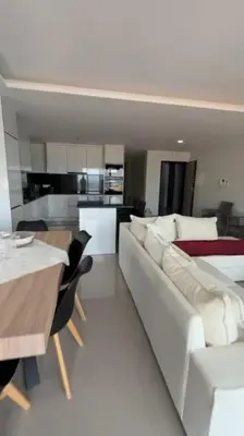 a living room with a white couch and a table at Appartement Vue Mer in Mindelo