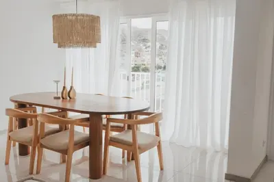 a dining room with a wooden table and chairs at Laginha Apartment in Mindelo