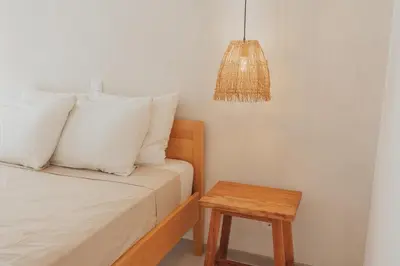 a bedroom with a bed with a table and a lamp at Laginha Apartment in Mindelo