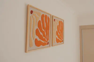 two framed pictures on a white wall at Laginha Apartment in Mindelo